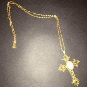 Costume gold cross with opal like stone.